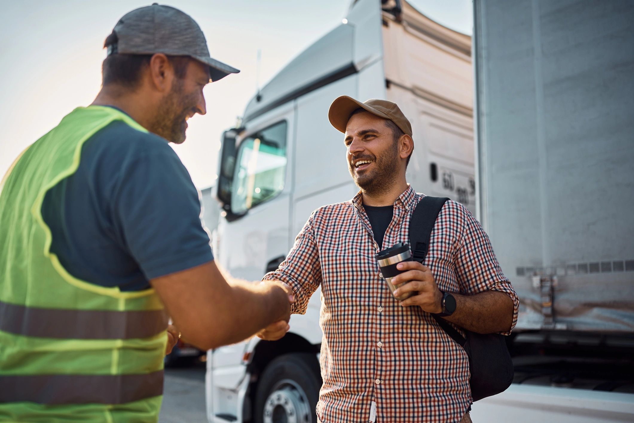 customer shaking hands with tow truck driver